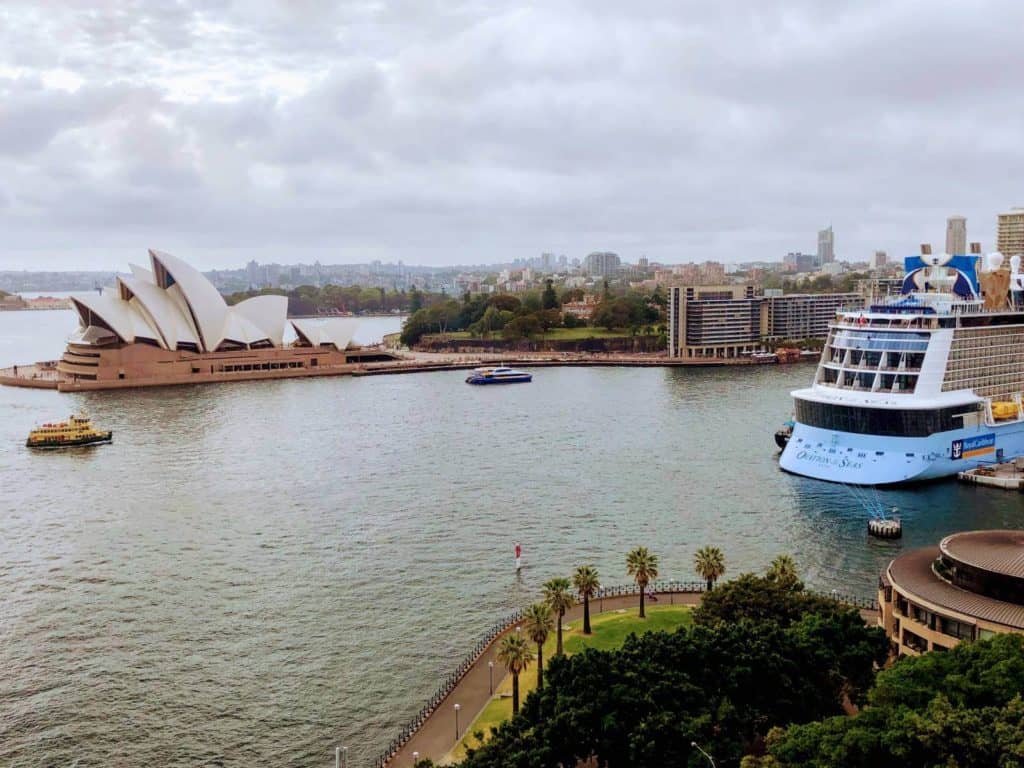 view of ferries and a cruise ship in a harbour with the sydney opera house