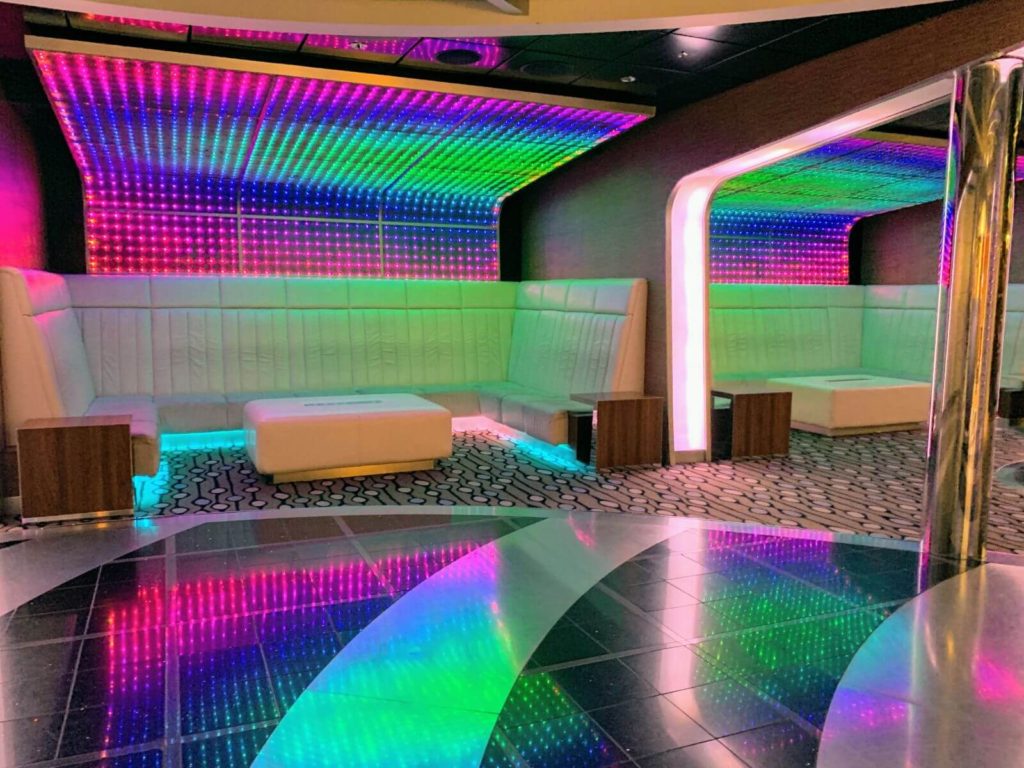 a nightclub with sofas and bright lights