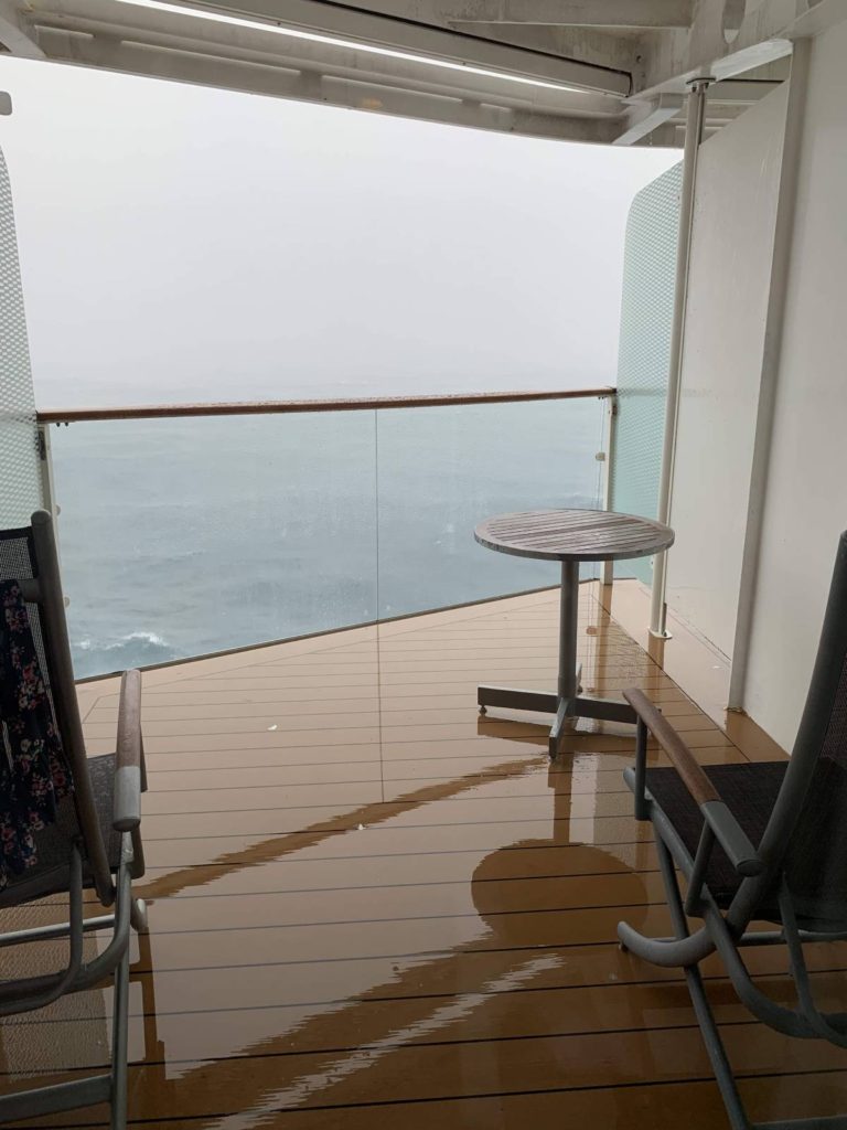 a cruise ship balcony on a wet rainy day at sea