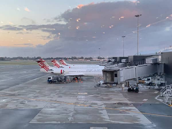 3 virgin australia planes on the tarmac being unloaded