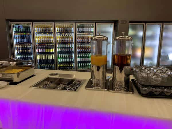 virgin australia perth business lounge with beer in cabinets and juice on the counter