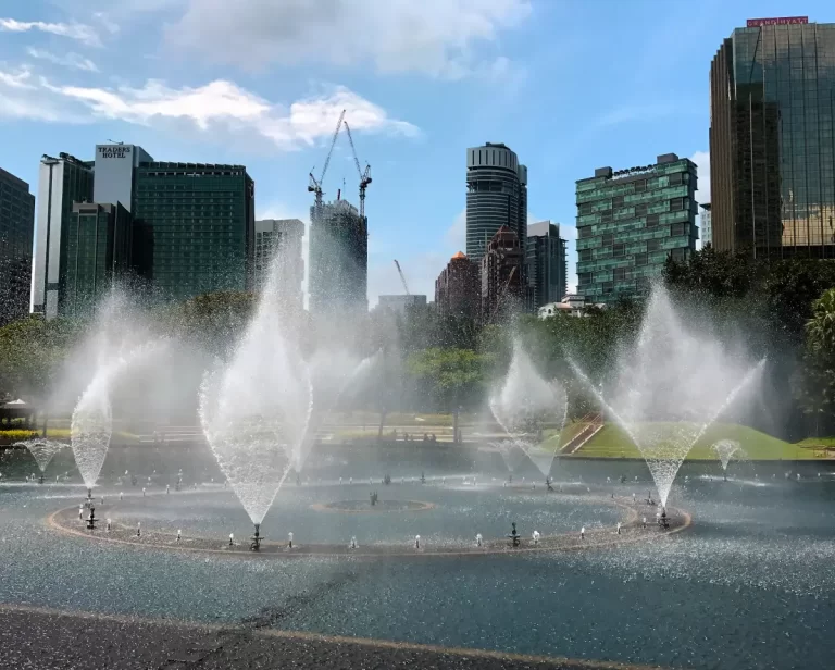 fountains in a lake in park during the day