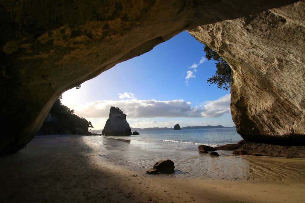 a cove with a rock in the shape of a cathedral