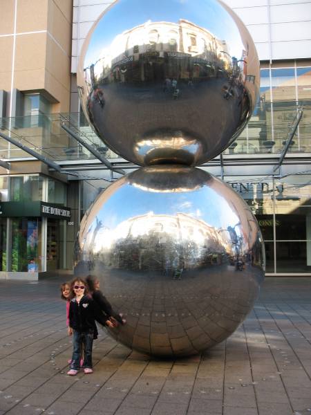 two stainless steel spheres in city shopping mall