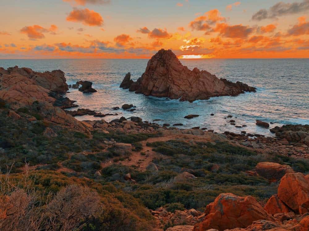 sunset over an island granite rock off the coast