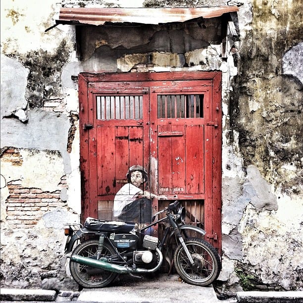 street art of a red door and a motorbike