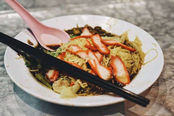 wan tan mee on white plate with chopsticks