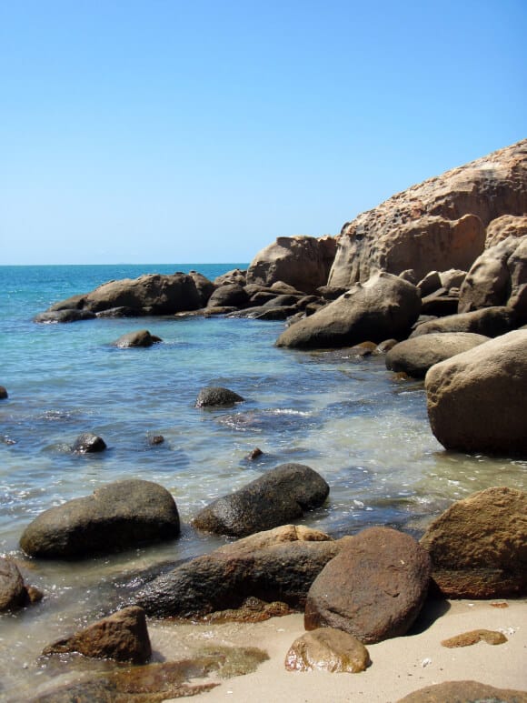 a rocky bay with clear ocean